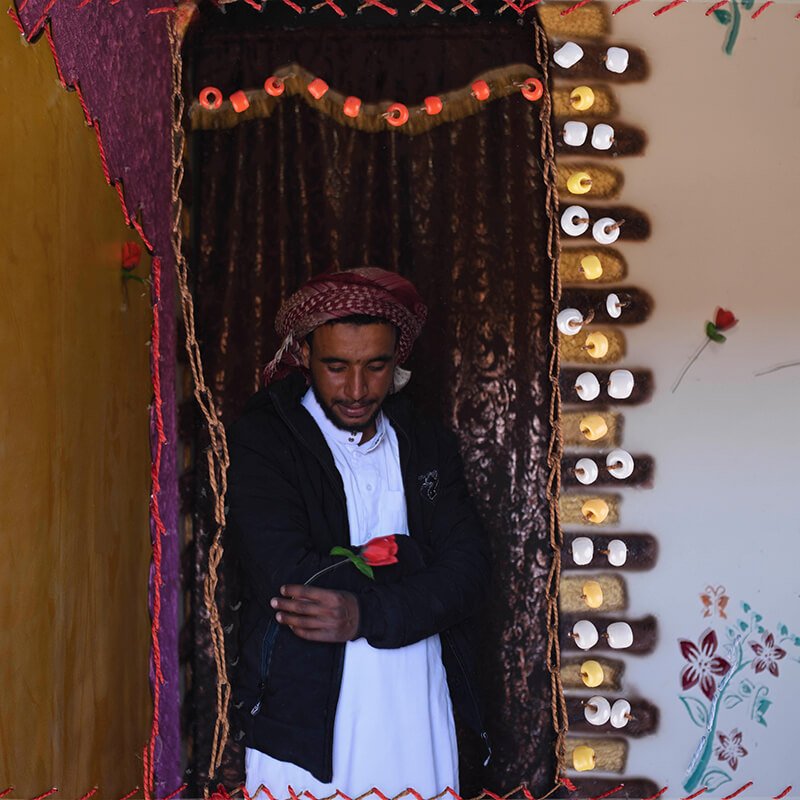 Photograph of a man holding a rose by Rehab Eldalil