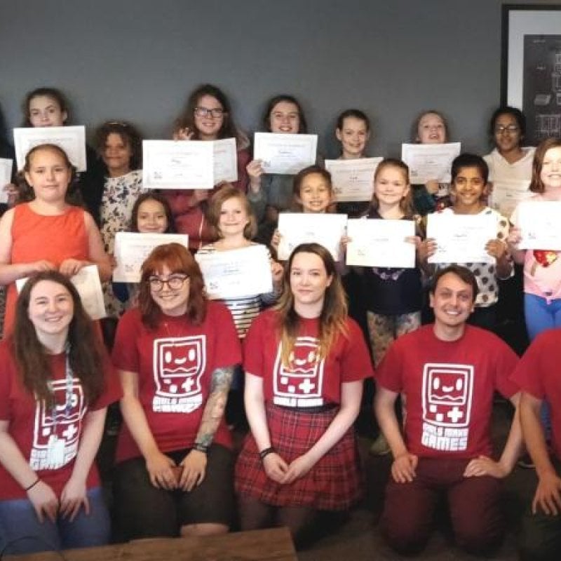 A group of young people wearing red t-shirts and holding certificates