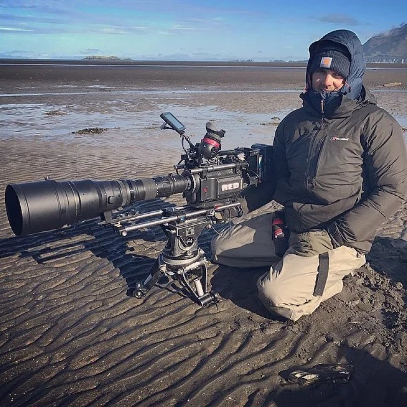 Sam Stweart filming on beach in Alaska