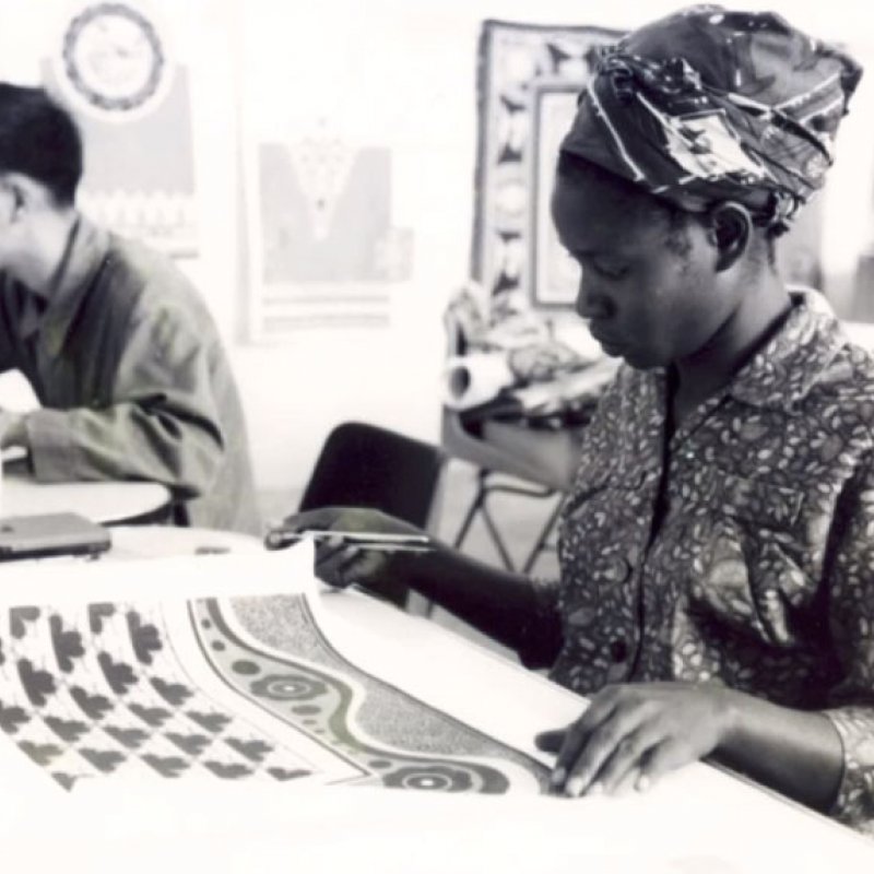 A woman examines textiles 