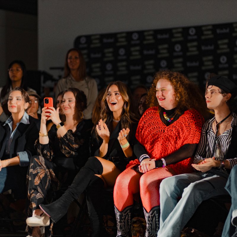 People sat on the front row of a catwalk
