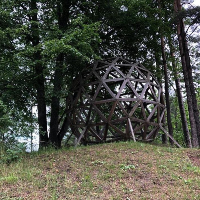 Andy Webster work photo depicting a large metal ball in the forest
