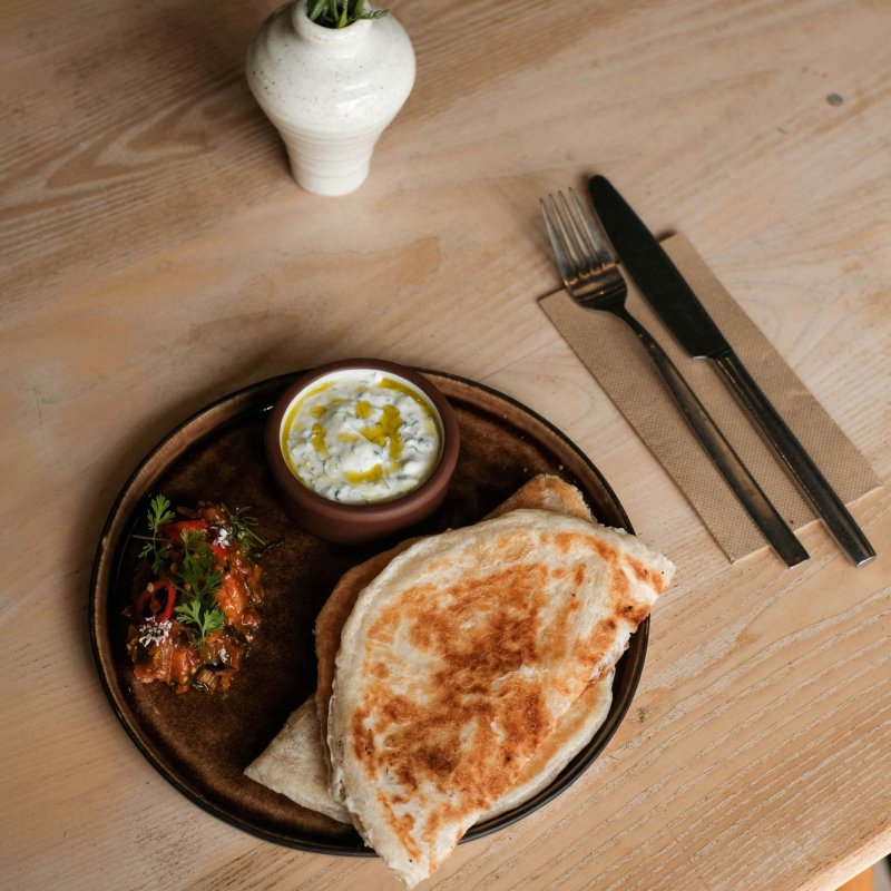 A table with flowers and a plate of food
