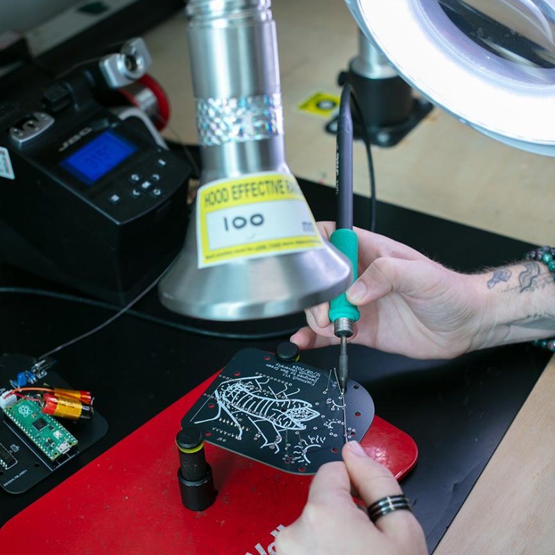A student using a soldering iron