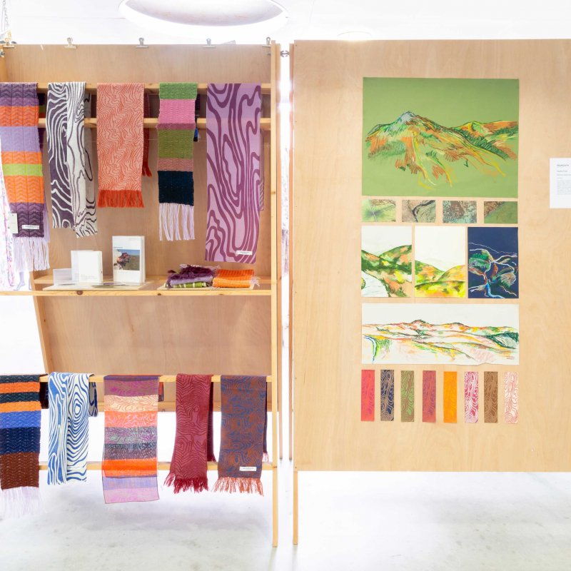 A series of colourful pieces of cloth and colourful sketches are placed alongside each other