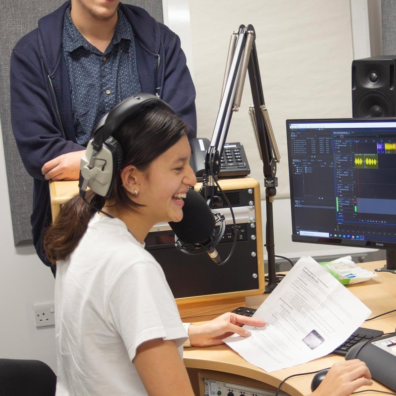 A female student working in an radio studio at Falmouth University
