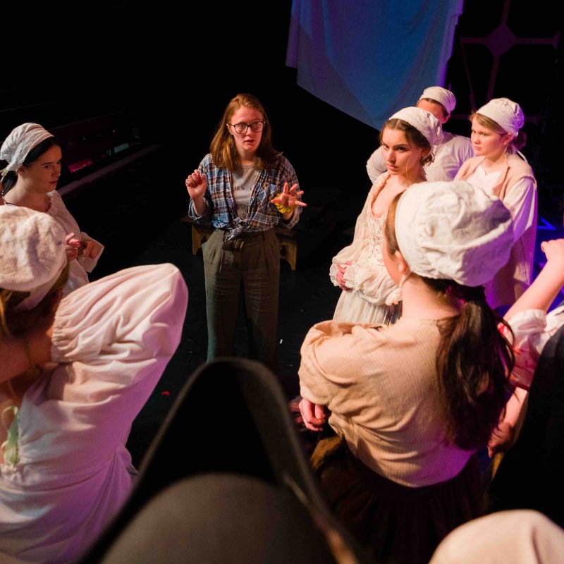 Group of acting students receiving stage directions