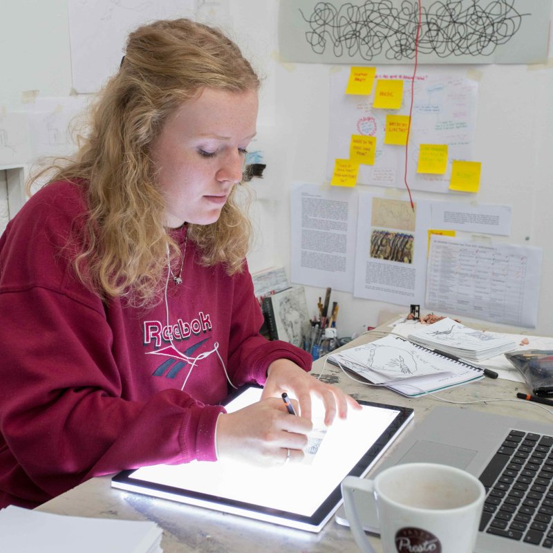 Student using art equipment