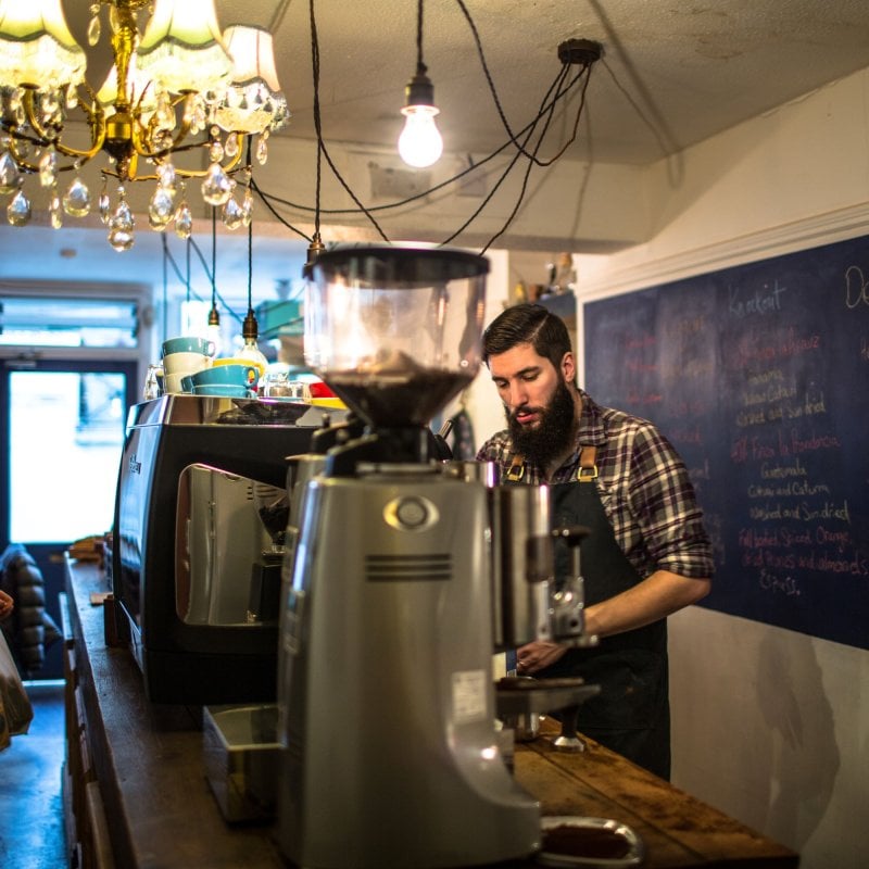 Man working behind the counter at a coffee shop