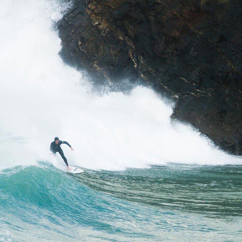 Surfer coming in on large wave.