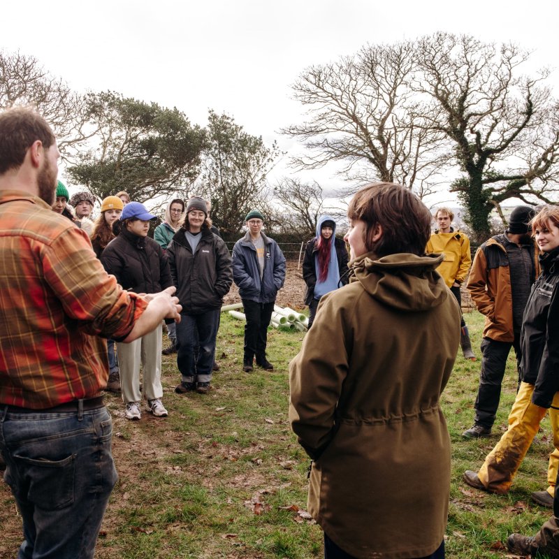 Volunteers listening to a talk during Falmouth University's community tree planting event