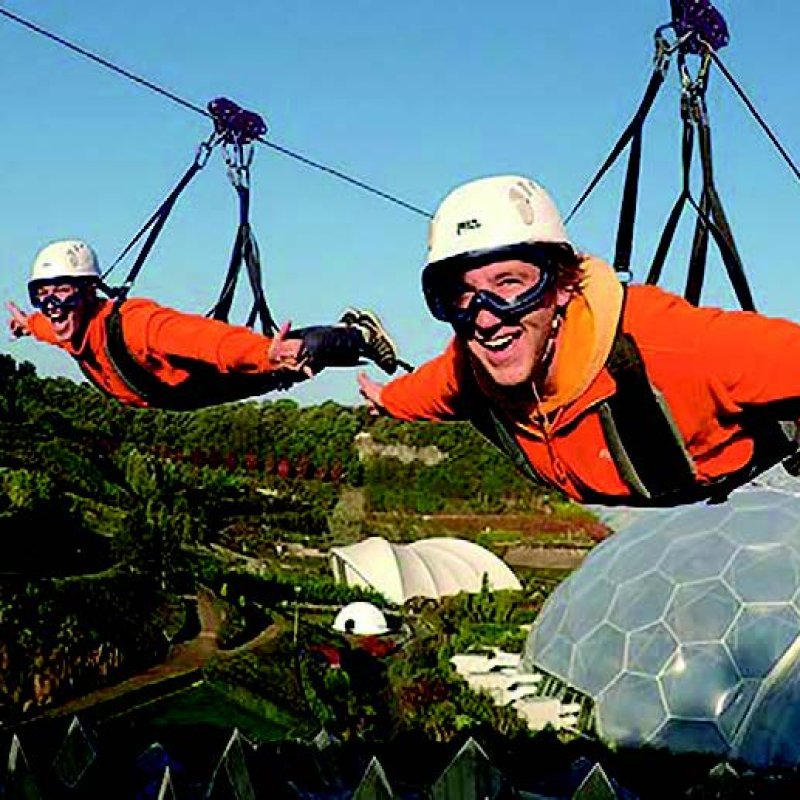 Two people on a zip line above The Eden Project