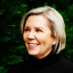 A blond woman smiling