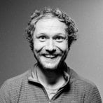Black and white photograph of a man smiling