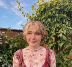 Photograph of Falmouth graduate Niamh Shergold outside with blue sky