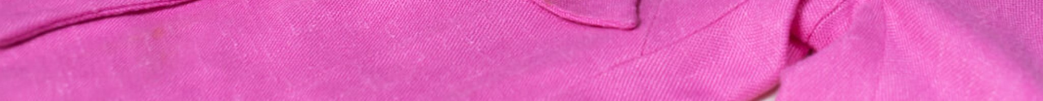 A bright pink jacket with gloved hands touching the garment