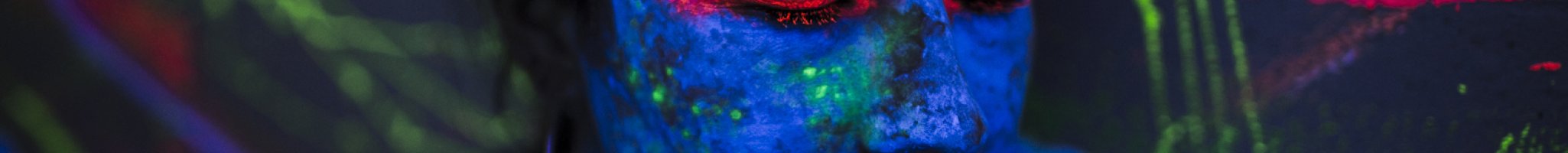 Lady with blue painted face and green and blue streaks on matching background.
