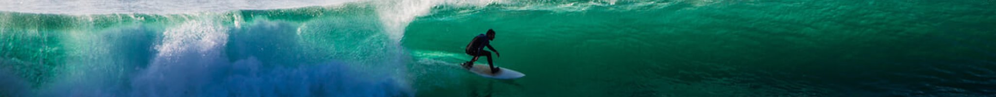 Surfer inside the tube of a wave