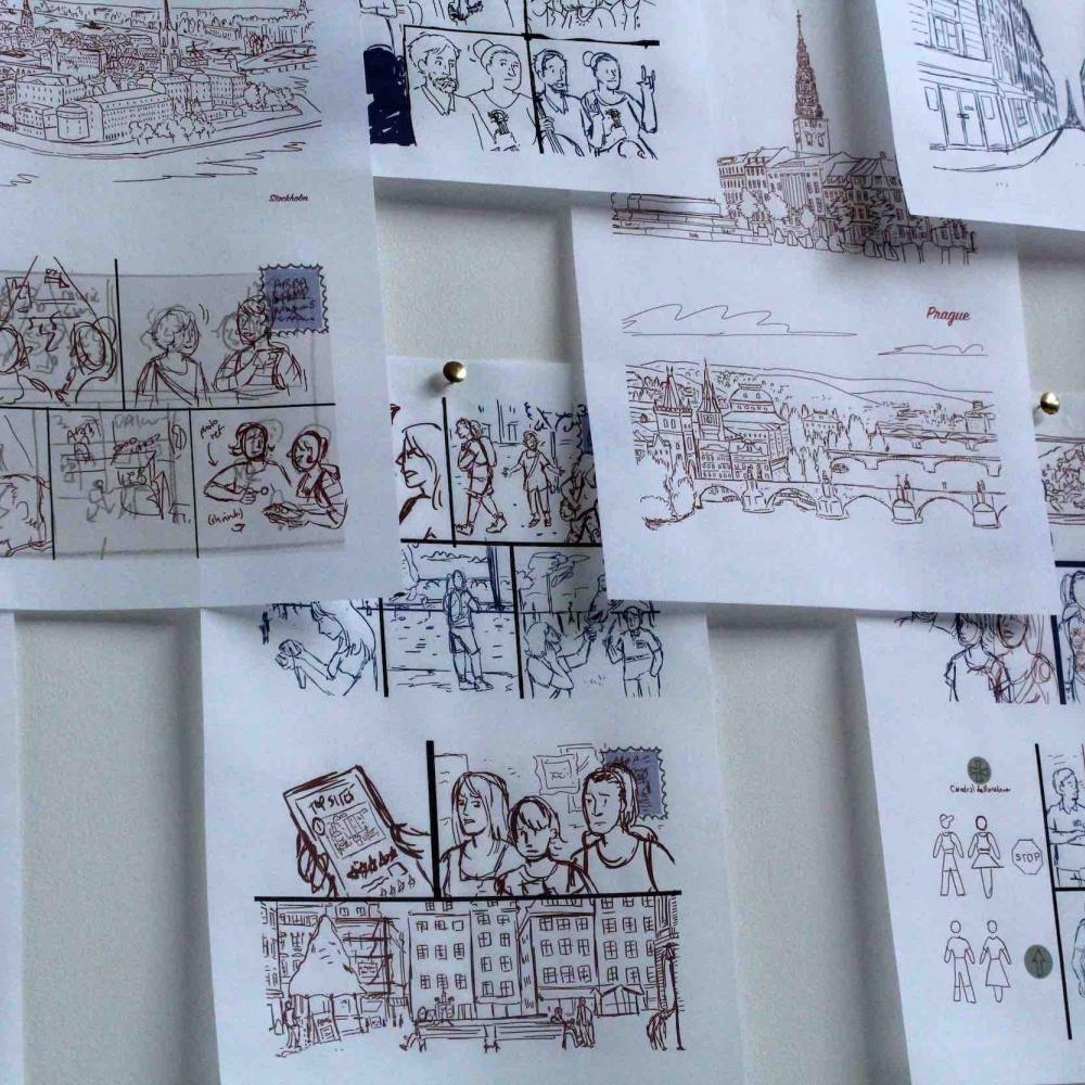 A selection of drawings on paper pinned to a wall