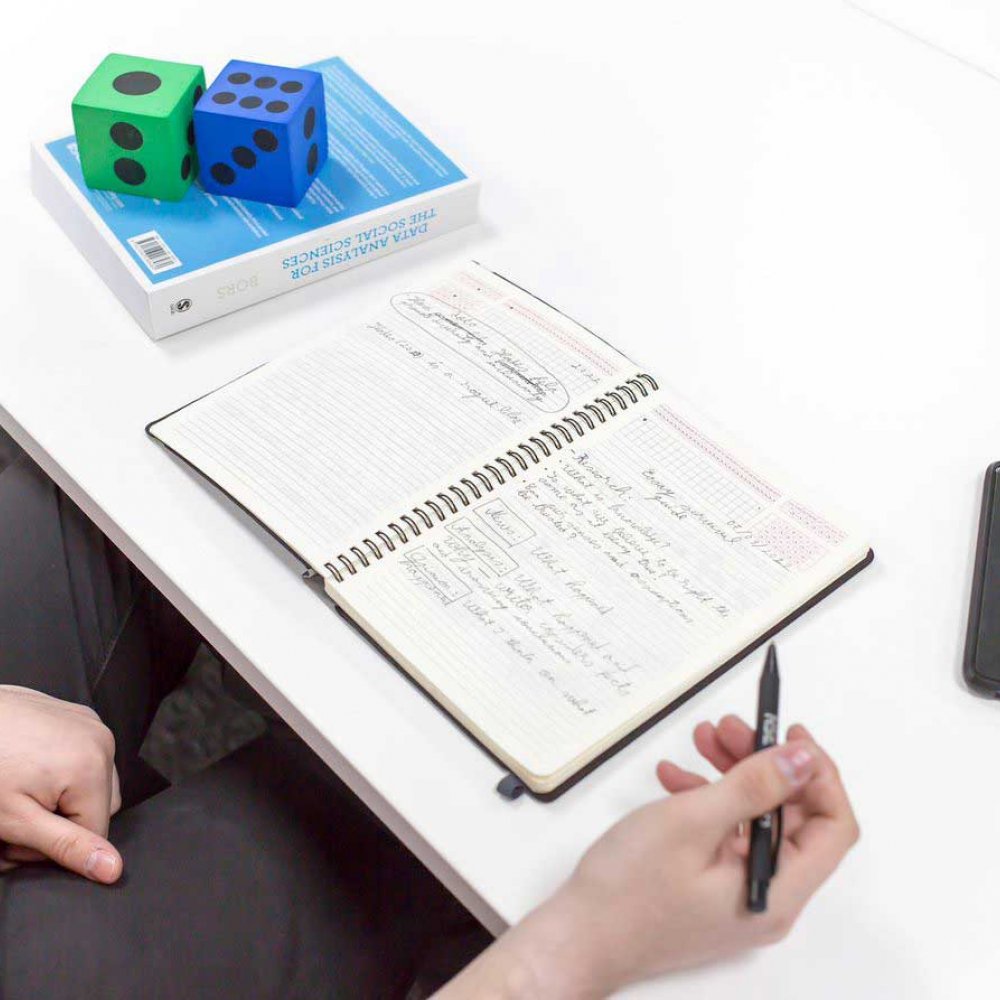 A student doing data calculations in a notebook