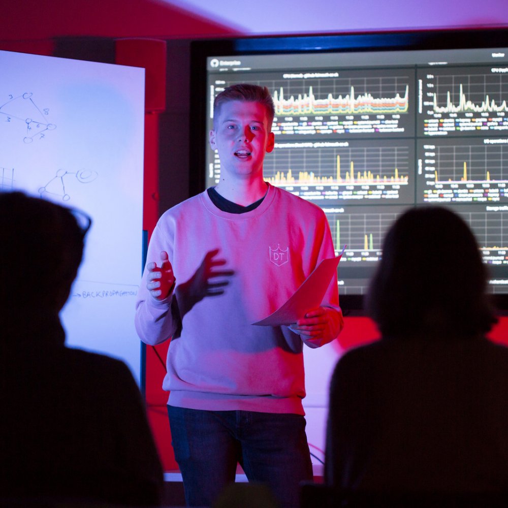 A student giving a presentation on coding