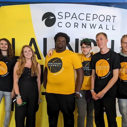 A group of students stand shoulder to shoulder wearing 'Spaceport Cornwall' tshirts