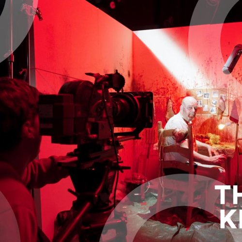 A Falmouth University student operating a camera on a red set