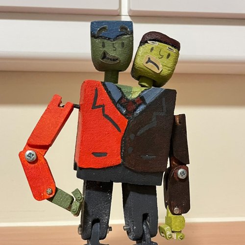 A wooden puppet with two heads by Liam Smith-Valle