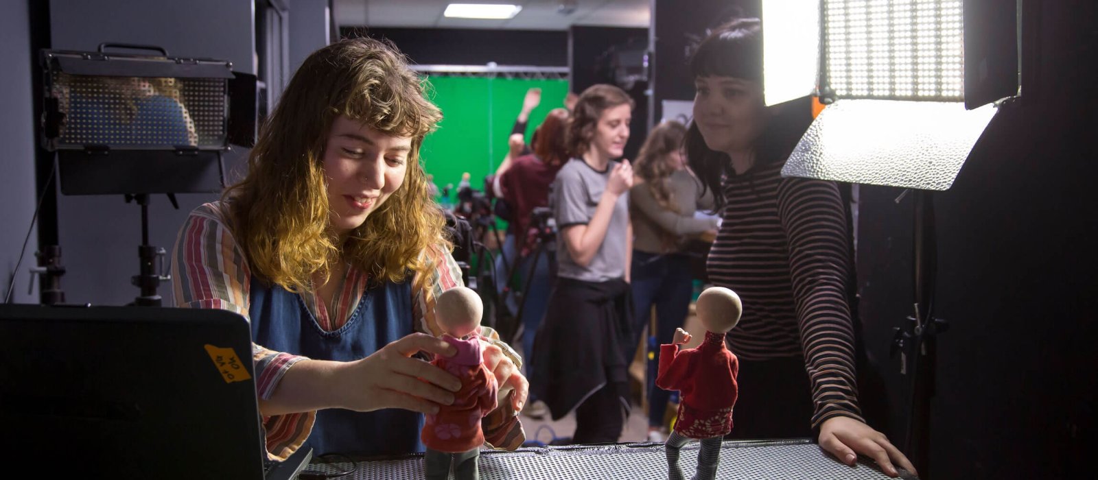 Animation student posing a model figure in a studio