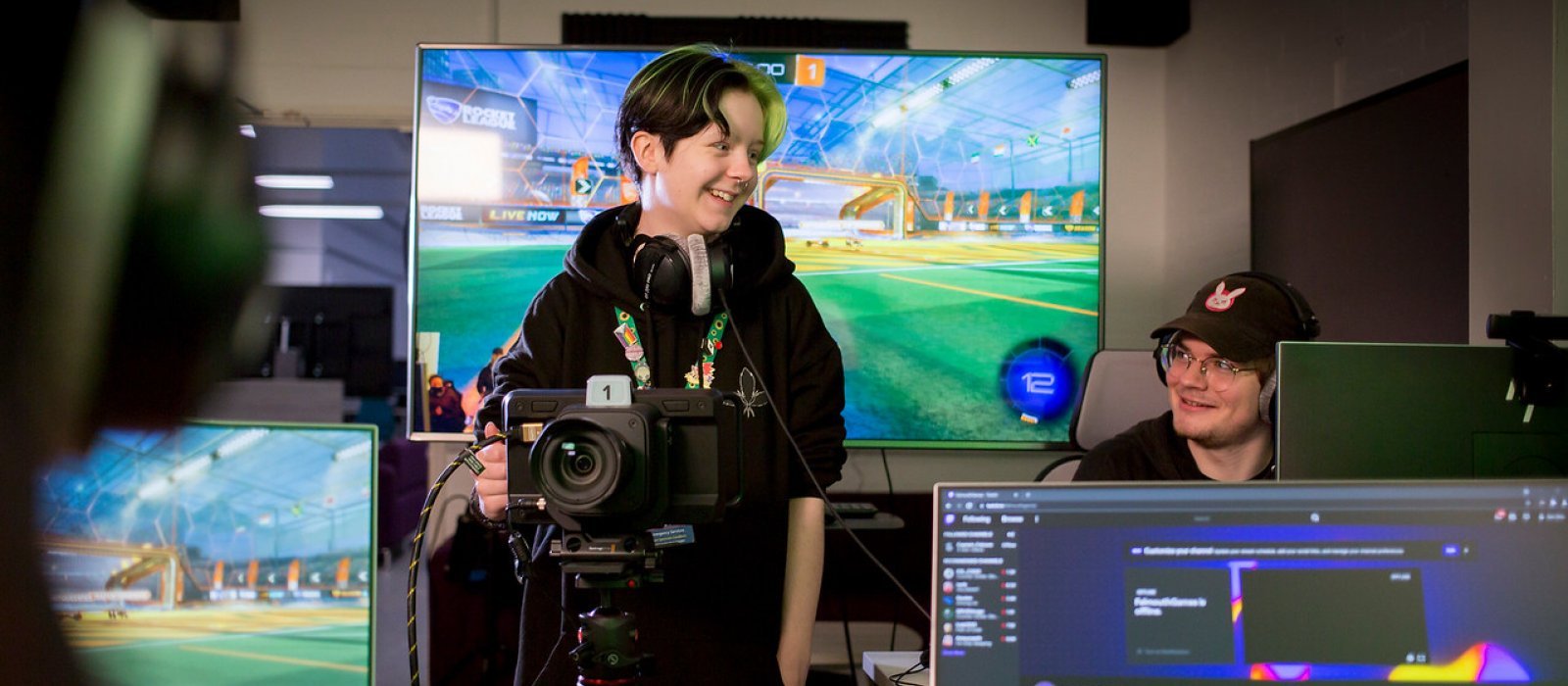 Two Falmouth University Esport students in a studio with screens