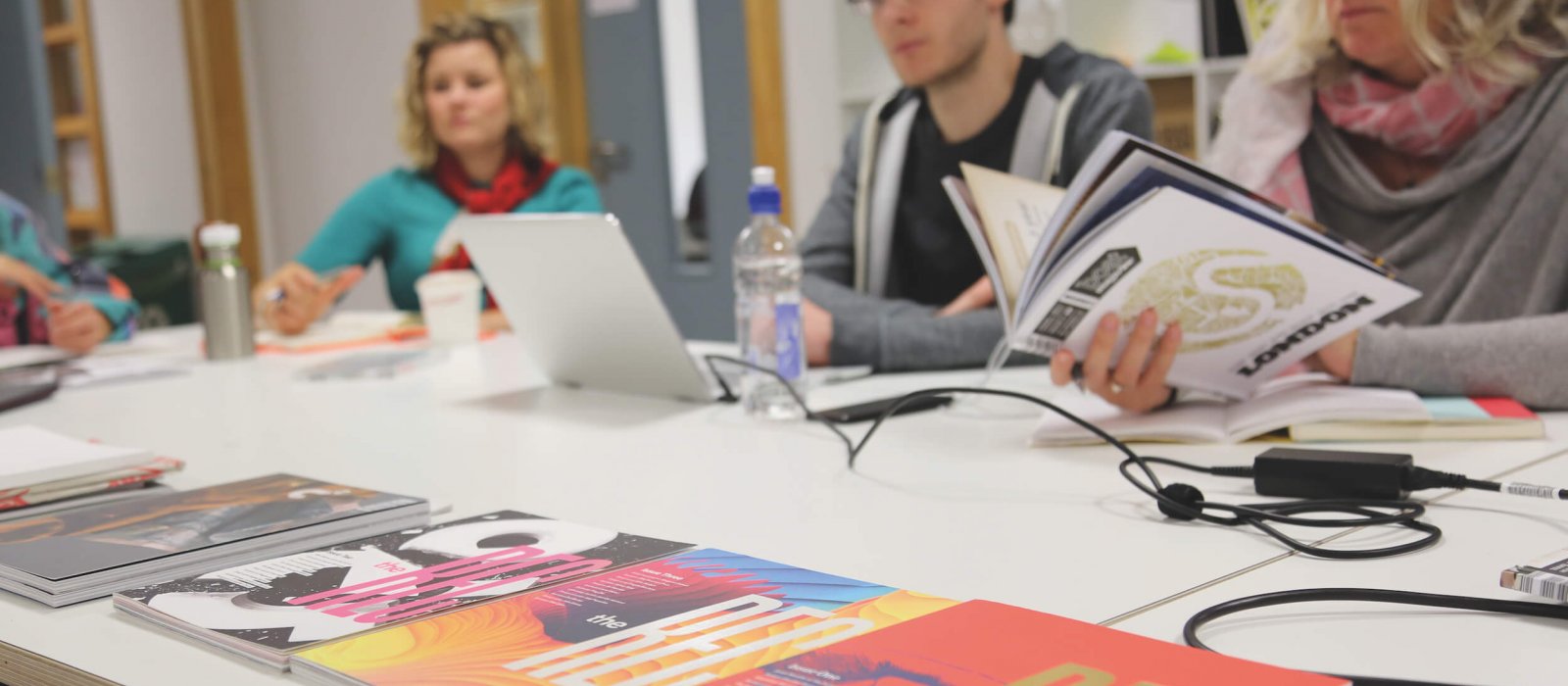 Falmouth University MA Graphic Design students at a table