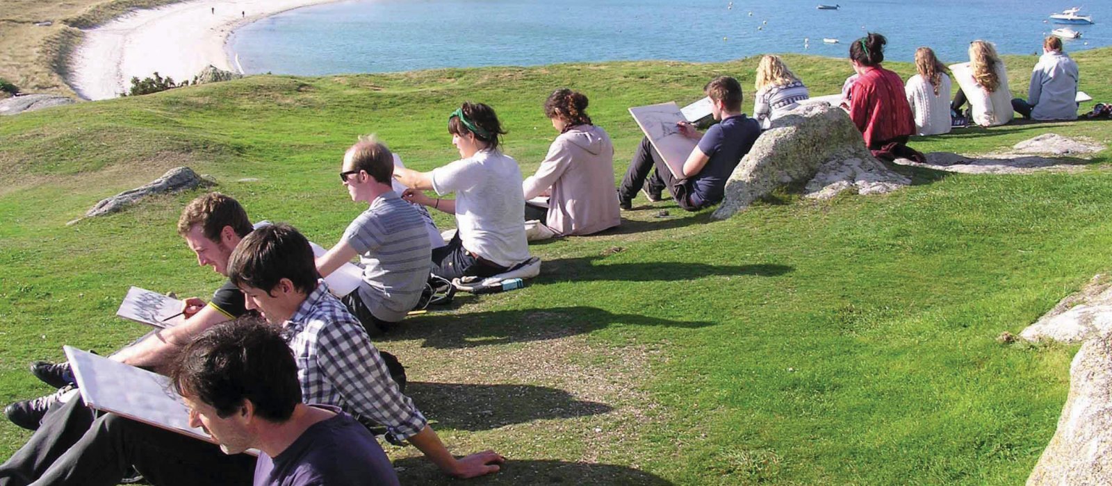 Falmouth University students on Tresco island drawing the scenery.