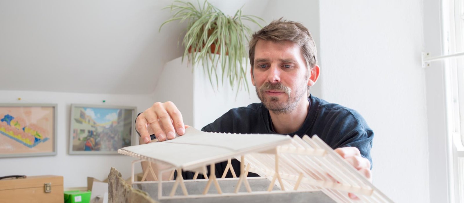 A Falmouth University Architecture student handling a model