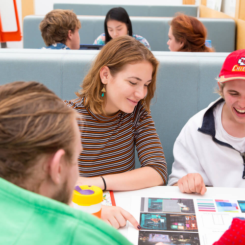 Four Falmouth University students sat around a table looking at a print out