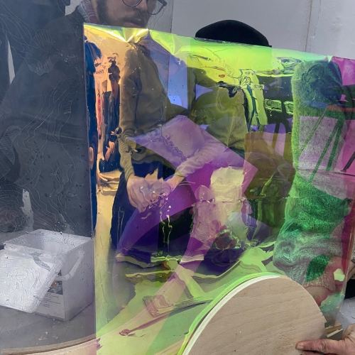Students working with materials to create a sculpture