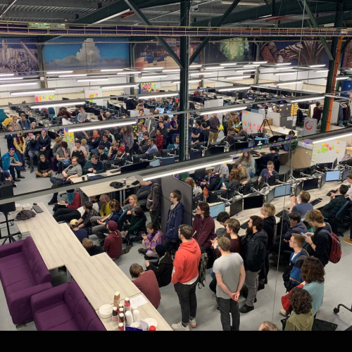 A crowd of students in the Games Academy with computers