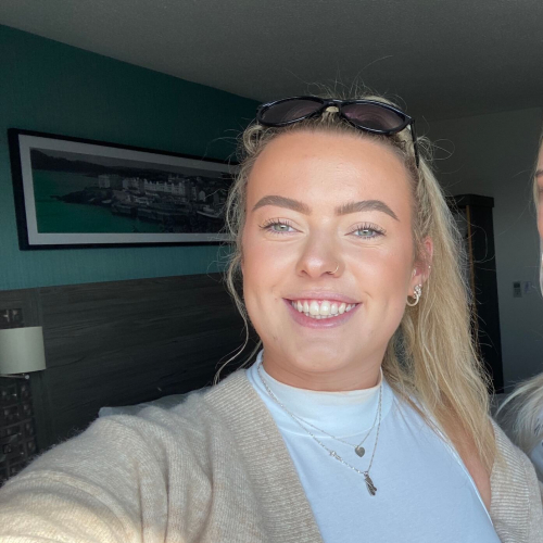 Falmouth University student smiling with blonde hair and a nose ring