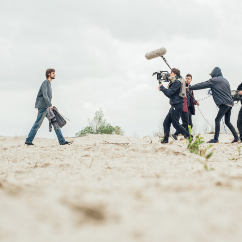 Origin Students man cameras and lighting equipment on the set of Origin