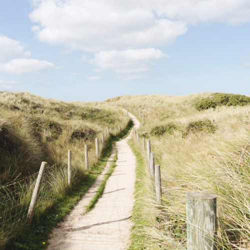 Path Student Life 1 A narrow path through sand dunes with blue sky