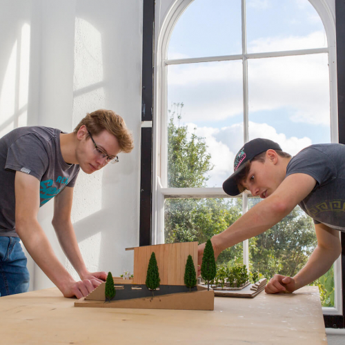 Two Falmouth University Architecture students examining model
