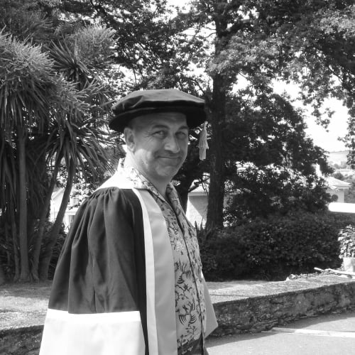 Falmouth honorary fellow Bill Mitchell in academic gown.