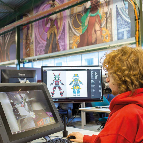 Student working on several screens in Falmouth University's Games Academy