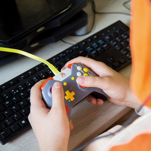 Close up of student hands on a games controller
