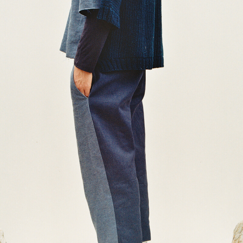 Head cropped model wearing two toned blue suit and black shoes