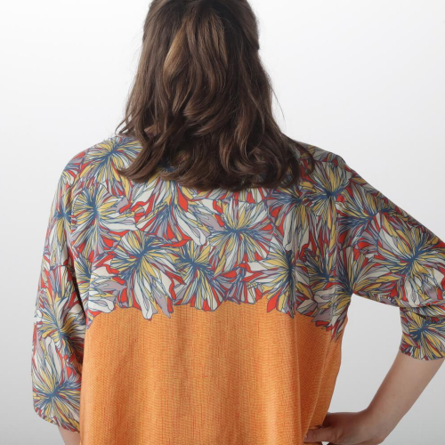 Model wearing jacket with digitally printed flower pattern.