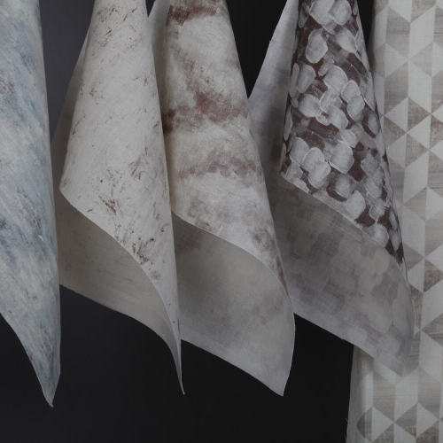 Samples of digitally printed fabric in whites and greys.