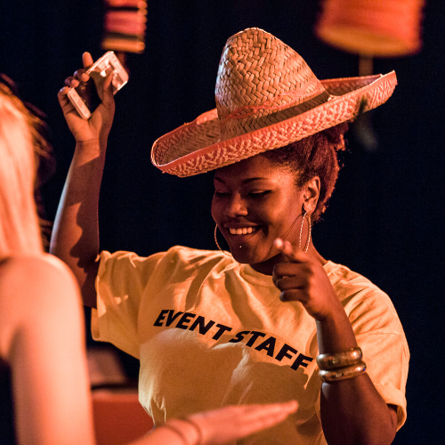 Falmouth student dancing with sombrero on at Mexican Fiesta event
