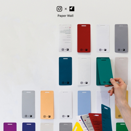 Wall of phone shaped coloured pieces of paper.