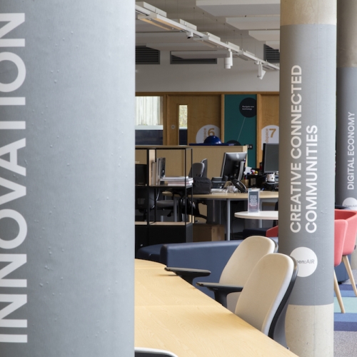 Building interior with innovation written on a grey pillar
