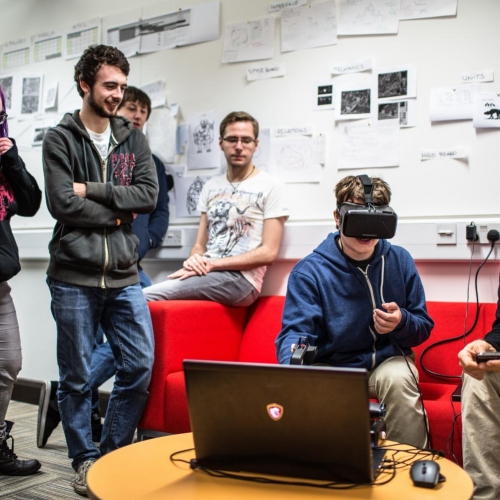 Student wearing a virtual reality headset with group of students